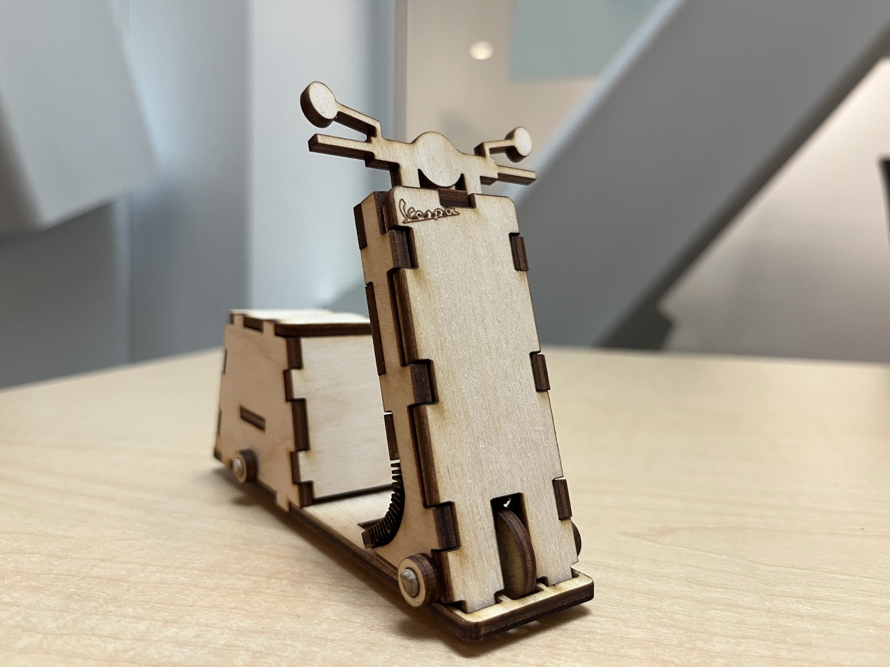 Vespa-Salt, a laser-cut kerf-bent birchwood salt shaker shaped like a Vespa scooter